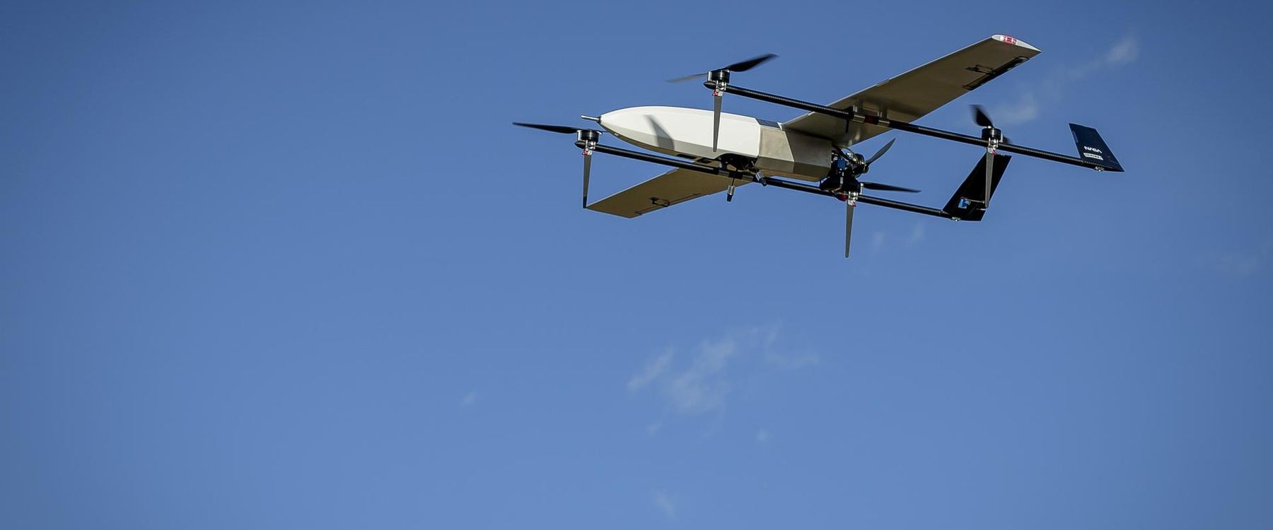 A small uncrewed research aircraft high in an otherwise empty blue sky.